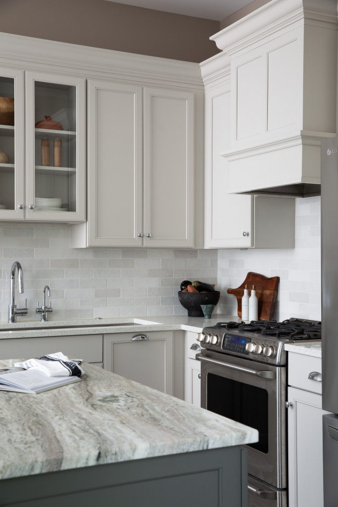 Inspiration for a huge u-shaped kitchen remodel with recessed-panel cabinets, beige cabinets, ceramic backsplash, stainless steel appliances, an island and white countertops