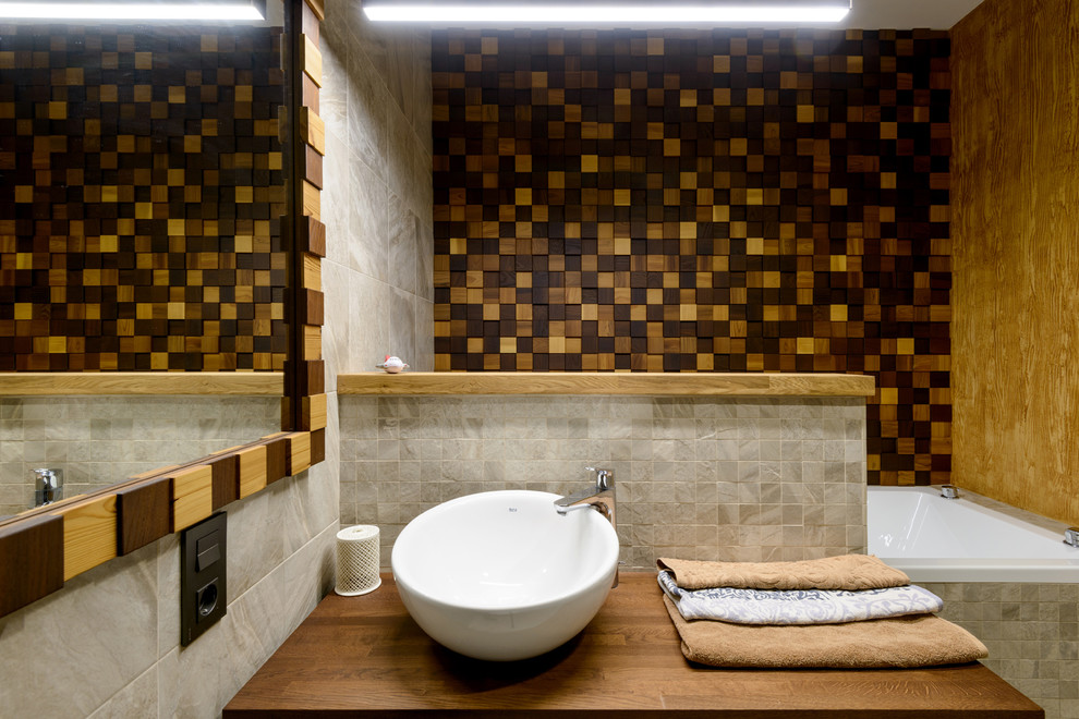 Scandinavian bathroom in Novosibirsk with brown tile and wood benchtops.