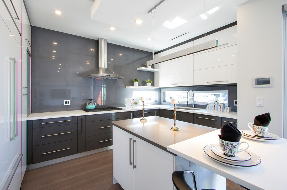 This is an example of a mid-sized contemporary u-shaped eat-in kitchen in Toronto with an undermount sink, flat-panel cabinets, grey cabinets, quartz benchtops, grey splashback, stainless steel appliances, light hardwood floors, with island and white benchtop.