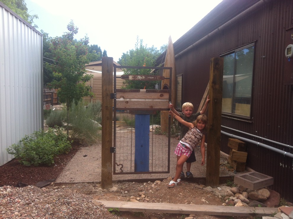 This is an example of a mid-sized rustic drought-tolerant and full sun backyard gravel garden path in Denver for fall.