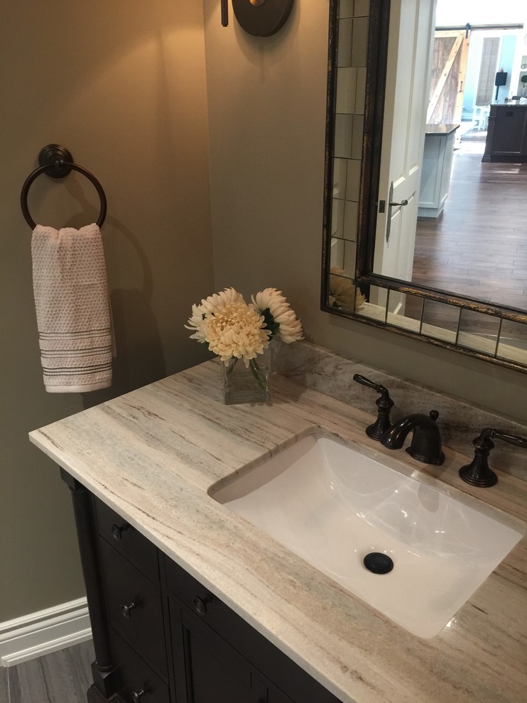 Inspiration for a large traditional powder room in Montreal with shaker cabinets, dark wood cabinets, gray tile, porcelain tile, beige walls, porcelain floors, an undermount sink and granite benchtops.