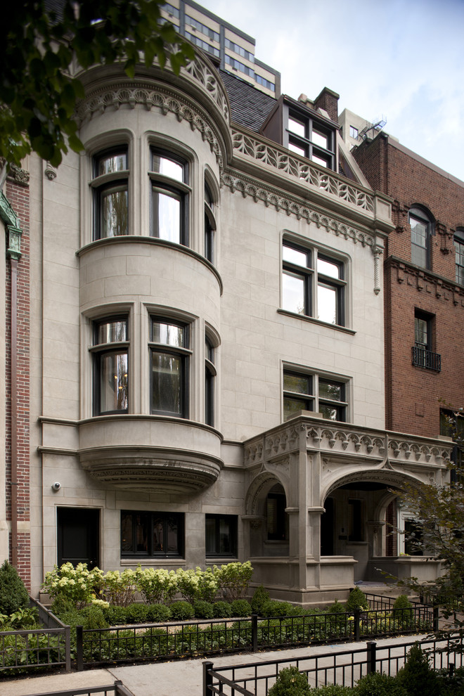 Inspiration for a traditional townhouse exterior in Chicago with stone veneer.