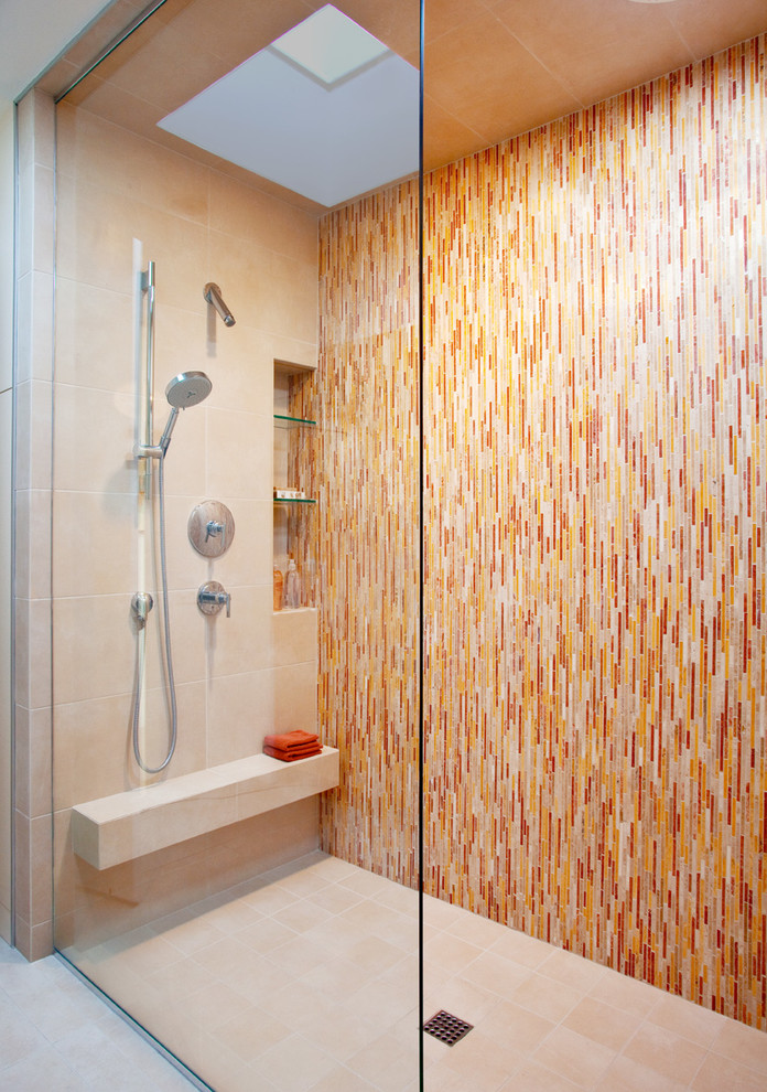 This is an example of a contemporary master bathroom in Los Angeles with multi-coloured tile, matchstick tile, white walls, ceramic floors, a curbless shower, a niche and a shower seat.