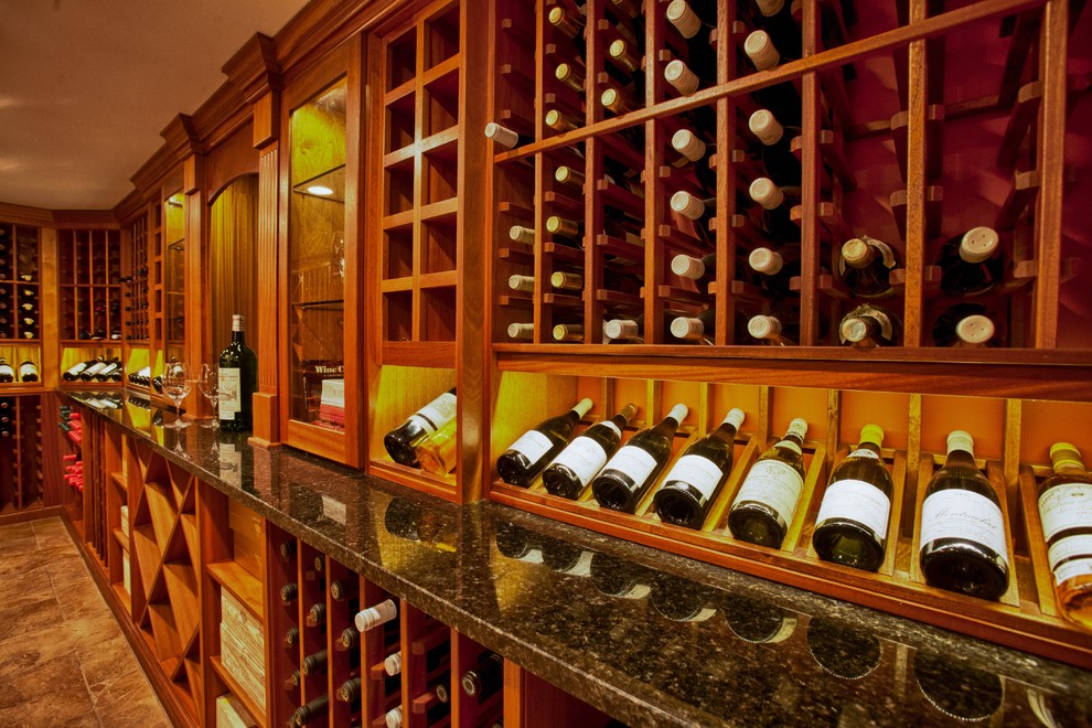 Traditional wine cellar in Boston with ceramic floors and display racks.