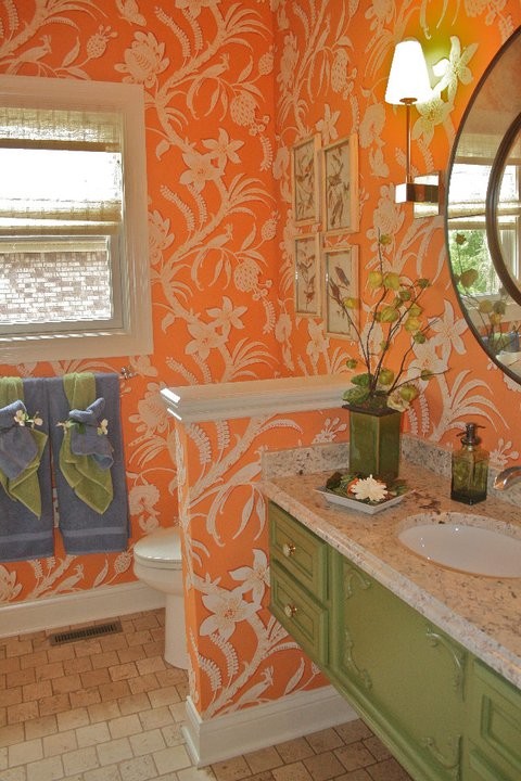 Beige tile bathroom photo with green cabinets and orange walls