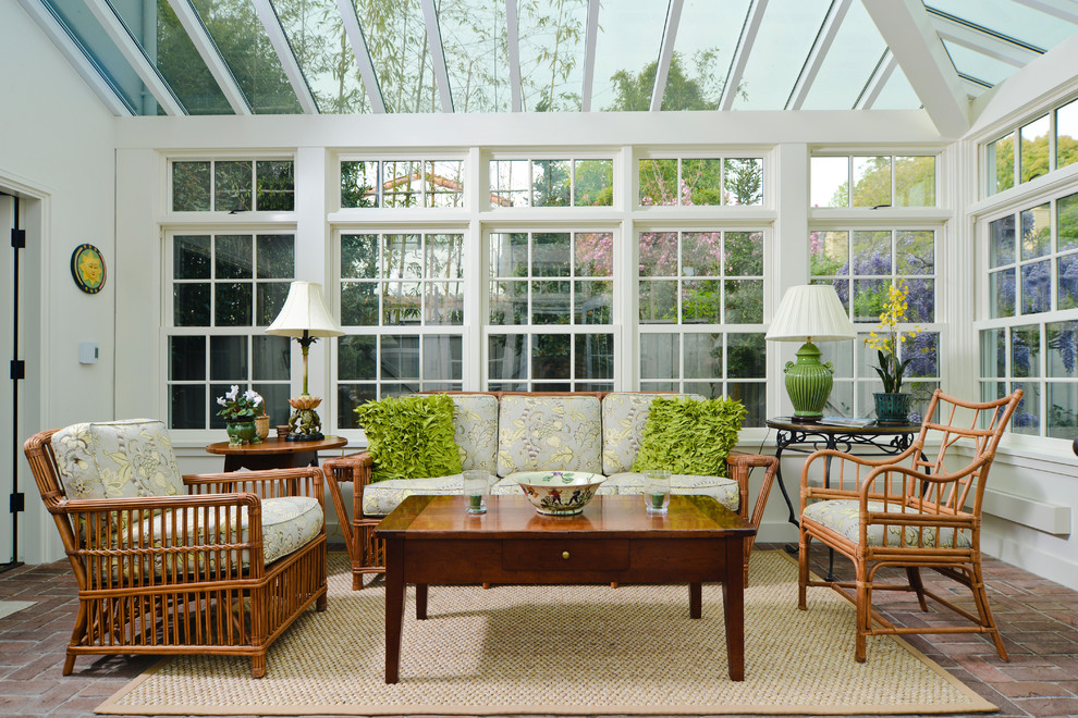 This is an example of a traditional sunroom in San Francisco with a glass ceiling and brick floors.