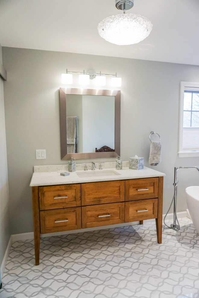 Example of a mid-sized transitional master marble floor, multicolored floor and single-sink toilet room design with flat-panel cabinets, brown cabinets, quartz countertops, a hinged shower door and a built-in vanity