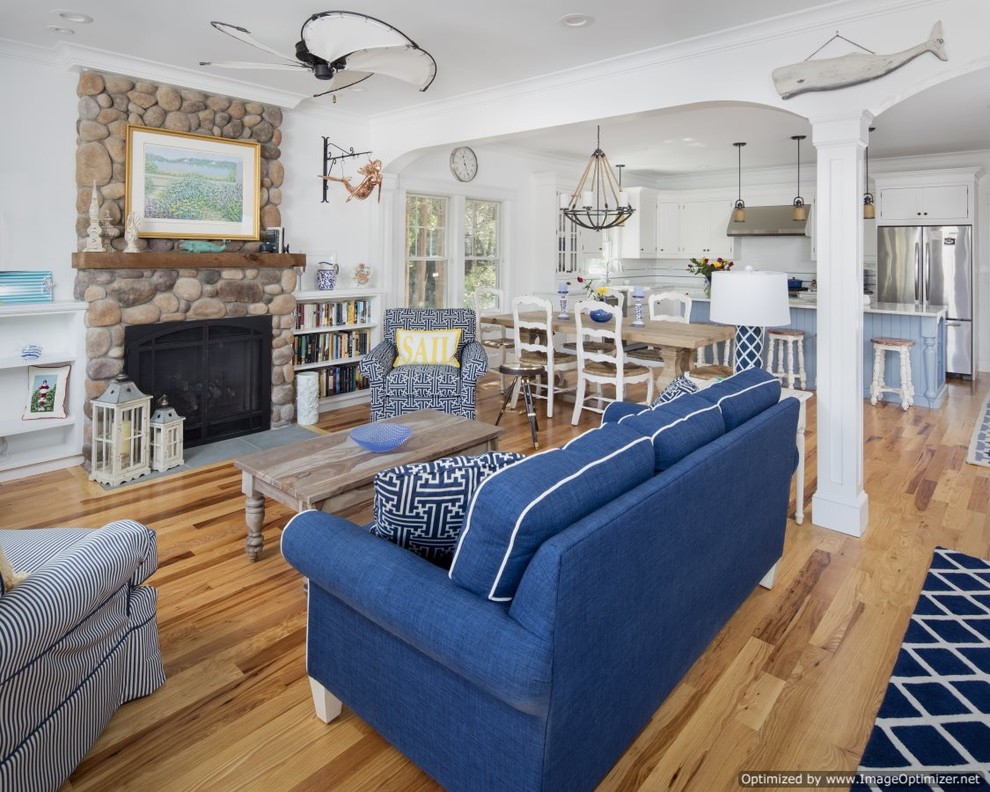 Mid-sized beach style open concept family room in Philadelphia with white walls, medium hardwood floors, a standard fireplace and a stone fireplace surround.