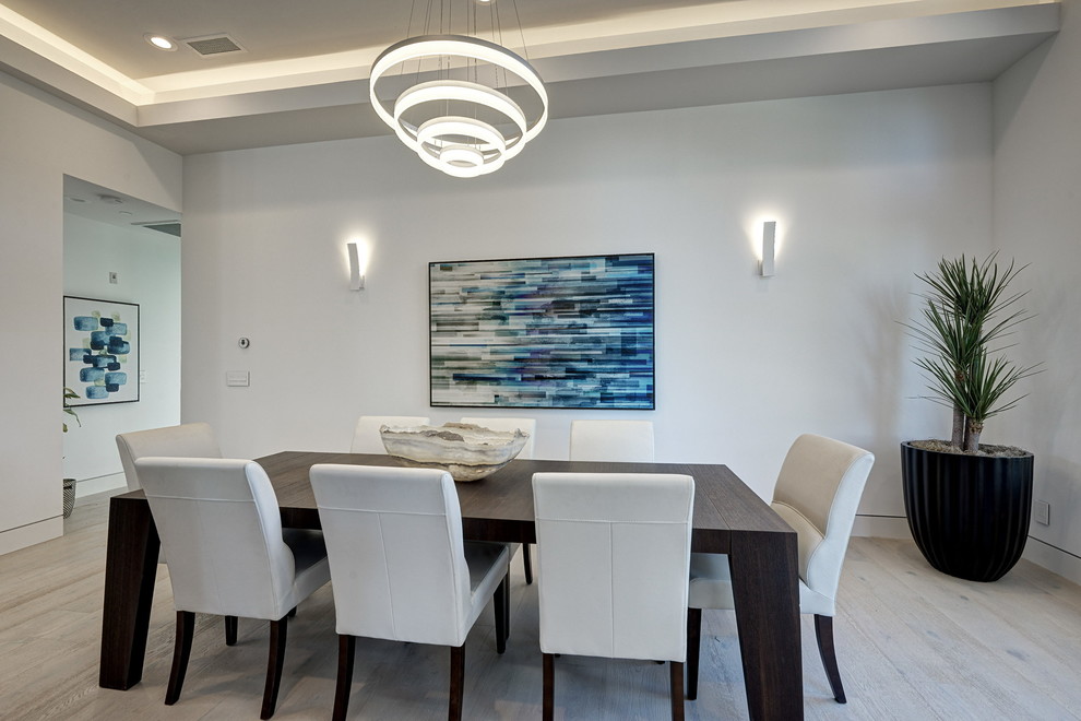 Inspiration for a large contemporary separate dining room in San Francisco with white walls and light hardwood floors.