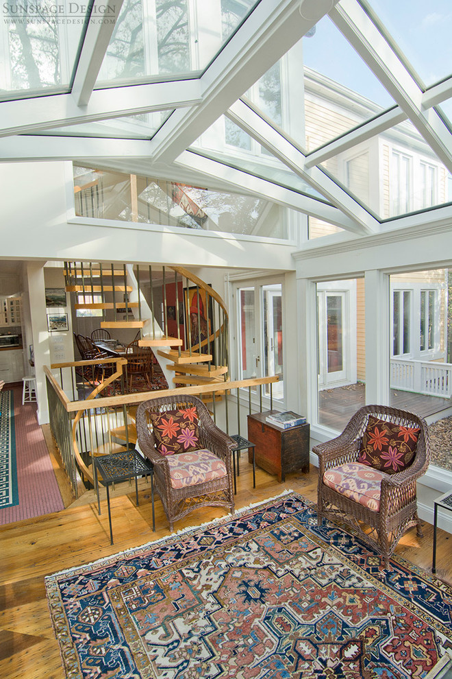 This is an example of a mid-sized country sunroom in Boston with medium hardwood floors, no fireplace and a glass ceiling.