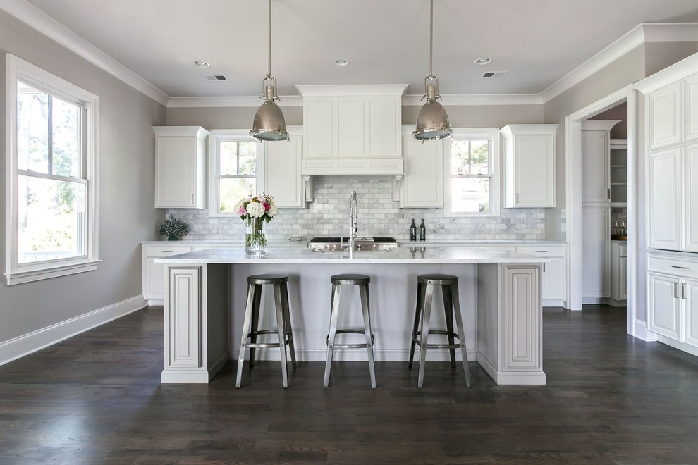 Photo of a mid-sized arts and crafts single-wall eat-in kitchen in Atlanta with grey cabinets, marble benchtops, grey splashback, stone tile splashback, stainless steel appliances, dark hardwood floors, with island and a farmhouse sink.