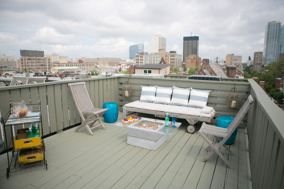 This is an example of a mid-sized beach style rooftop deck in Philadelphia with an awning.