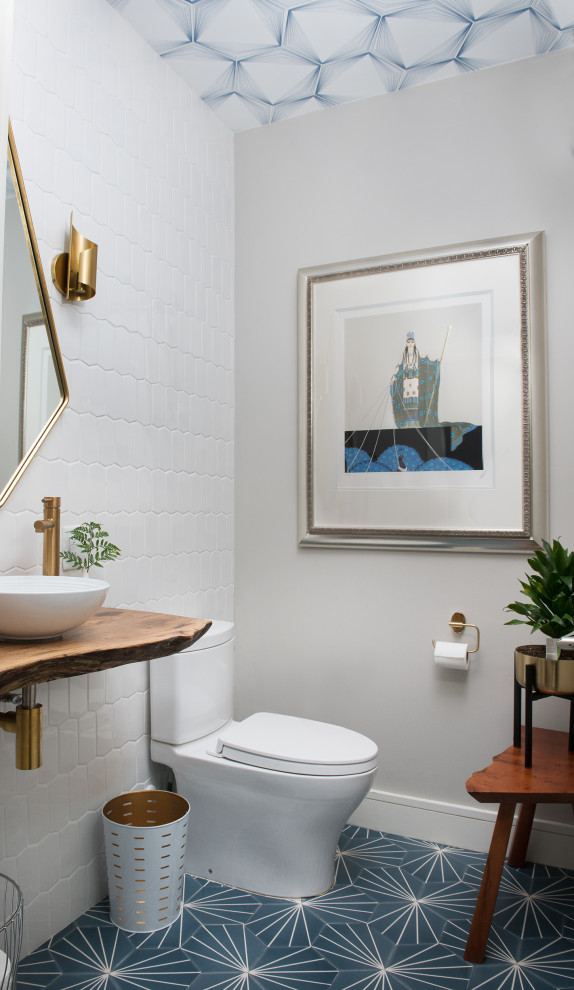 Design ideas for a midcentury powder room in Houston with white tile, grey walls, a vessel sink, wood benchtops, blue floor, brown benchtops, vaulted and wallpaper.