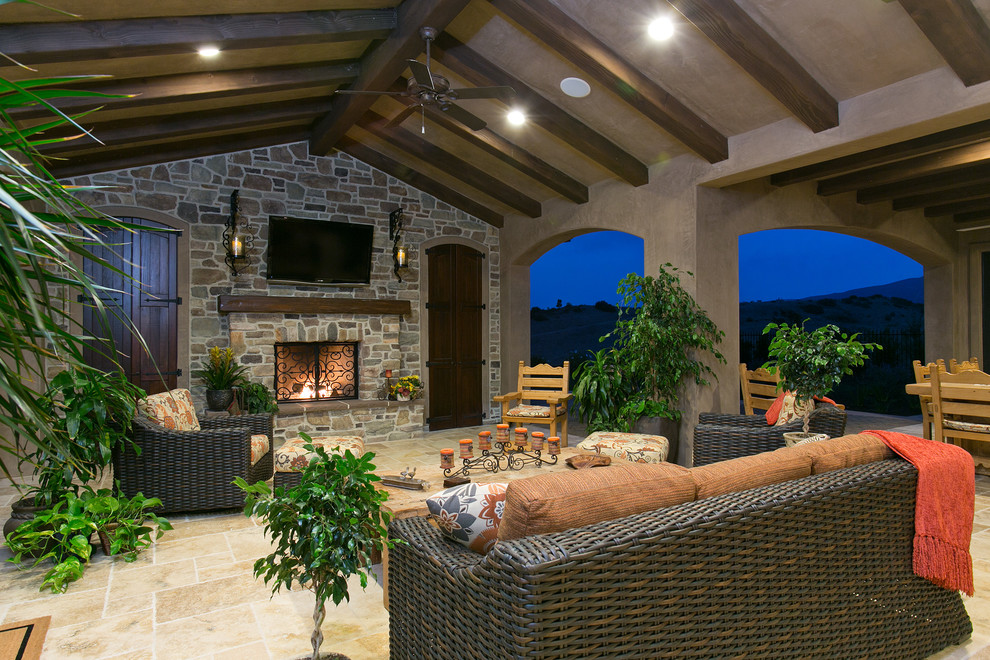 Design ideas for a traditional patio in San Diego with a fire feature and a roof extension.