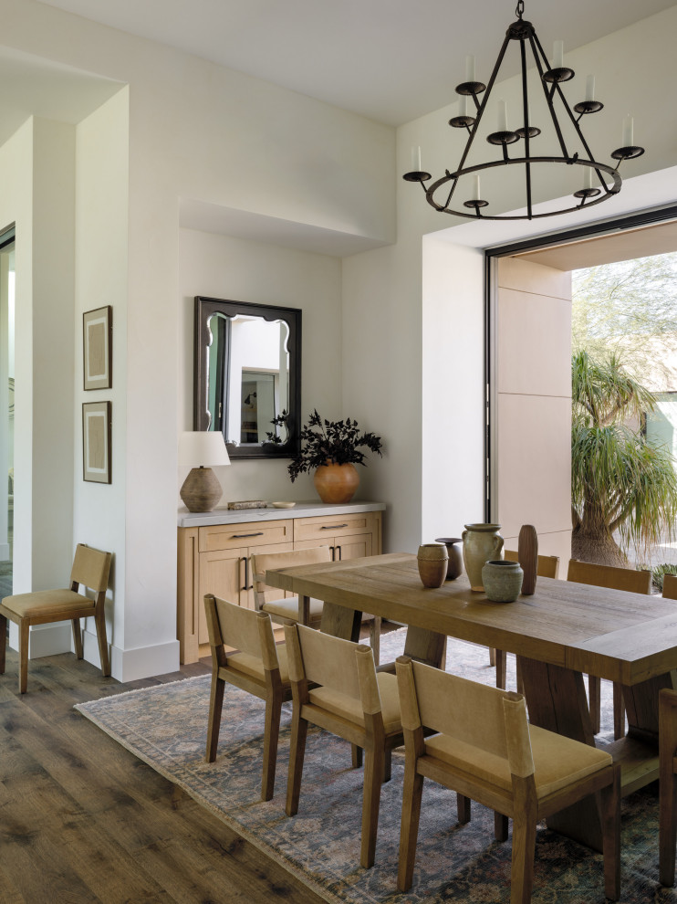 Great room - large southwestern medium tone wood floor and brown floor great room idea in Other with white walls