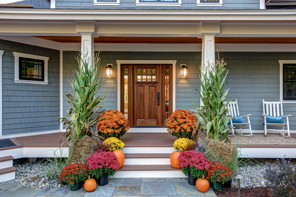 Entryway - mid-sized craftsman brown floor entryway idea in Boston with blue walls and a medium wood front door