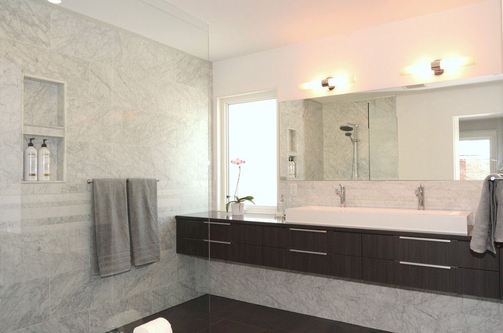 Inspiration for a mid-sized contemporary master bathroom in Ottawa with a vessel sink, flat-panel cabinets, grey cabinets, quartzite benchtops, a curbless shower, a one-piece toilet, gray tile, stone tile, white walls and porcelain floors.