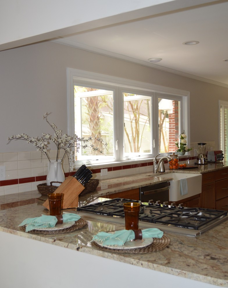 Eat-in kitchen - large transitional l-shaped porcelain tile and beige floor eat-in kitchen idea with a farmhouse sink, raised-panel cabinets, brown cabinets, granite countertops, white backsplash, ceramic backsplash, stainless steel appliances and a peninsula