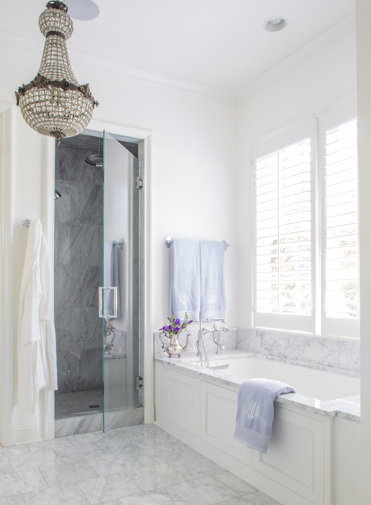 Design ideas for a large traditional master bathroom in Other with shaker cabinets, white cabinets, a drop-in tub, a two-piece toilet, gray tile, stone slab, white walls, marble floors, a drop-in sink and marble benchtops.