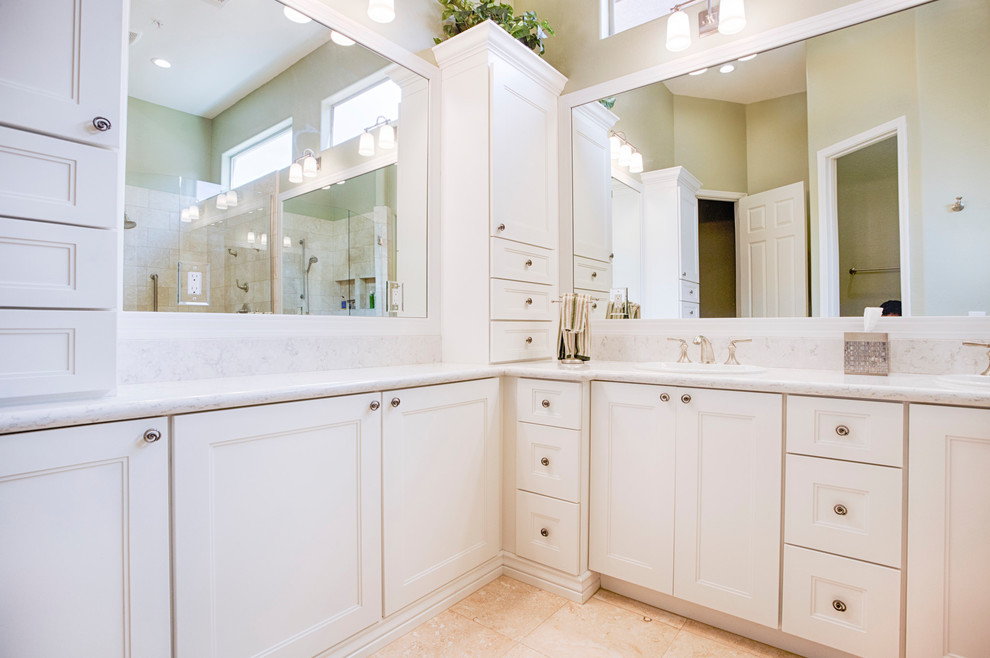 Large transitional master beige tile and travertine tile travertine floor corner shower photo in Phoenix with recessed-panel cabinets, white cabinets, green walls, an undermount sink and granite countertops