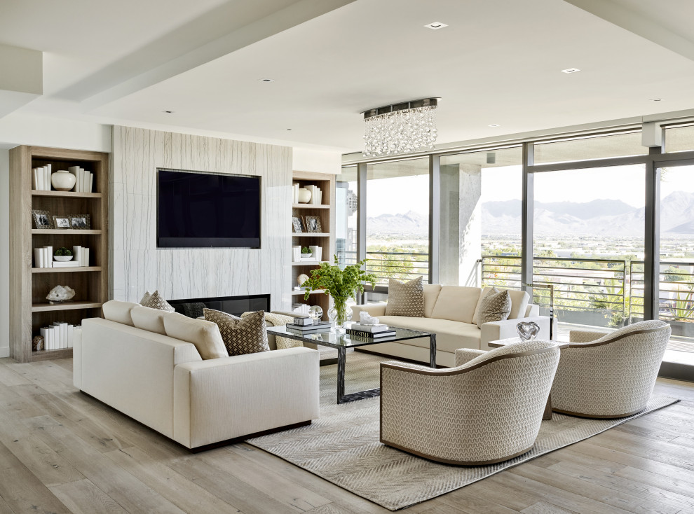 Large contemporary open concept living room in Phoenix with white walls, light hardwood floors, a ribbon fireplace, a tile fireplace surround, a built-in media wall and beige floor.