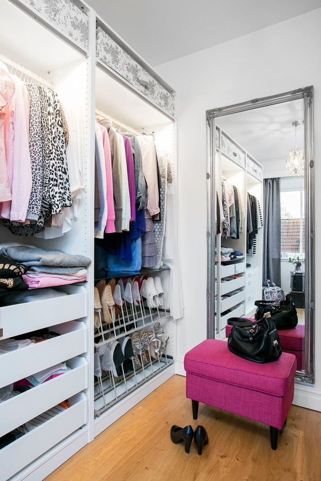 Inspiration for a large modern women's storage and wardrobe in Malmo with open cabinets.