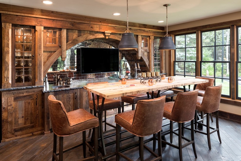 Traditional single-wall seated home bar in Minneapolis with dark hardwood floors, brown floor, an undermount sink, glass-front cabinets, dark wood cabinets and metal splashback.