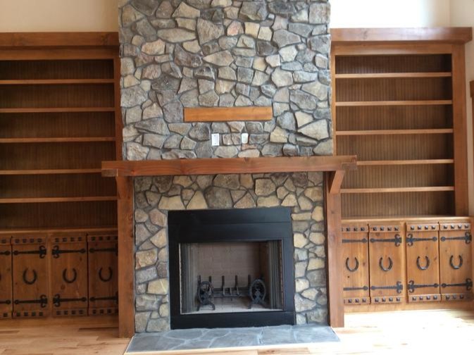 Living room - medium tone wood floor living room idea with beige walls, a standard fireplace and a stone fireplace