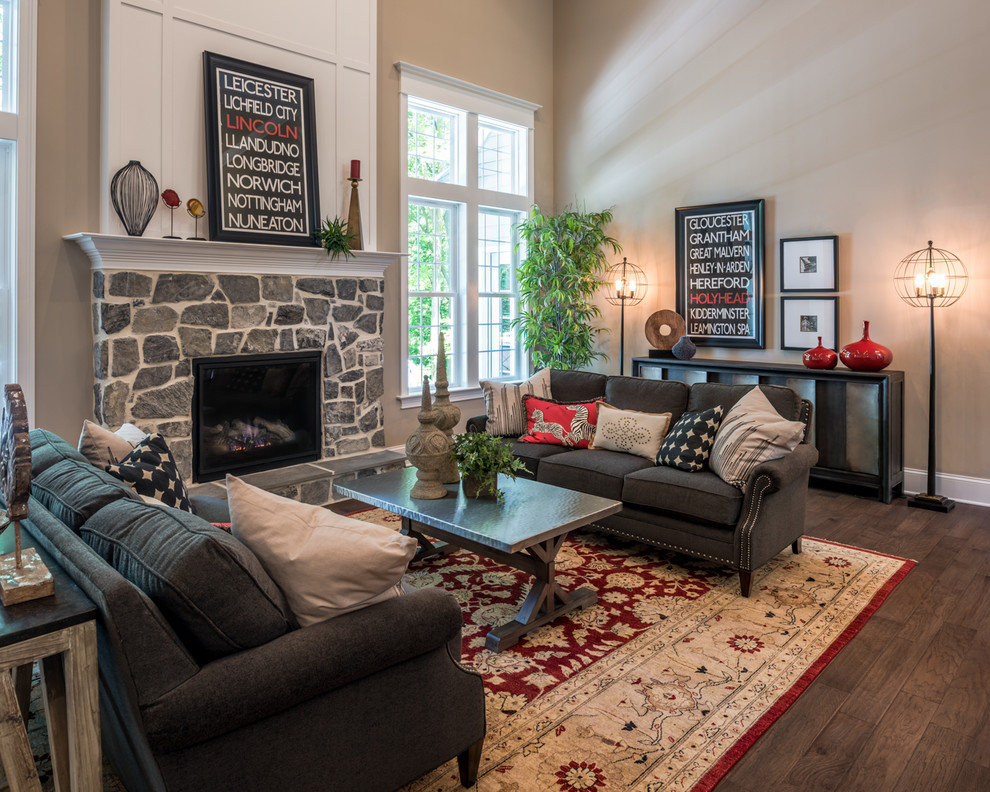 Inspiration for a traditional formal living room in Other with beige walls, medium hardwood floors, a standard fireplace and a stone fireplace surround.