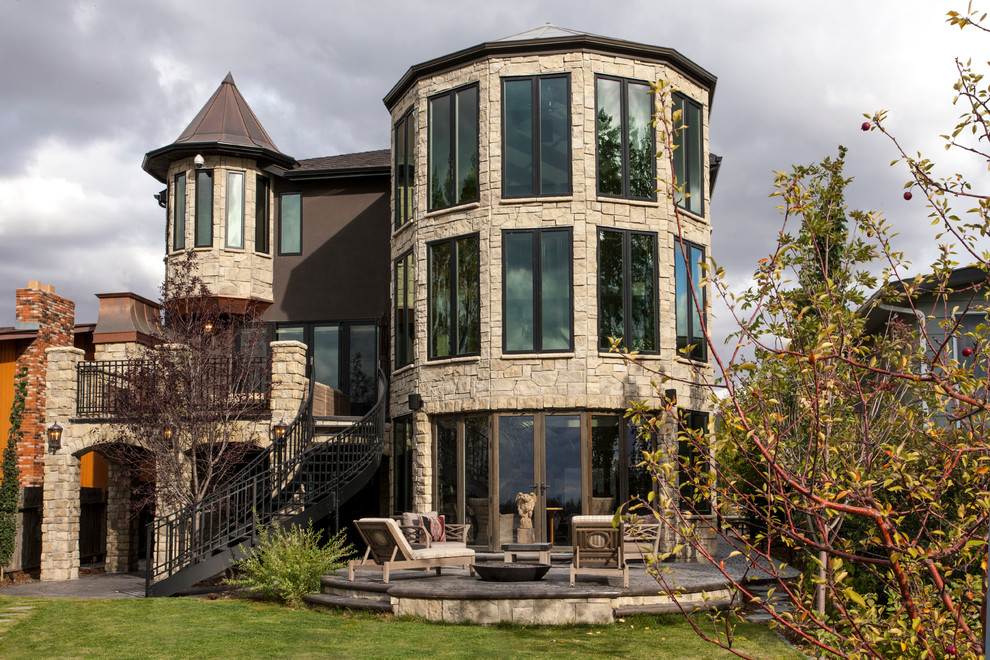 This is an example of a traditional three-storey exterior in Calgary with stone veneer.