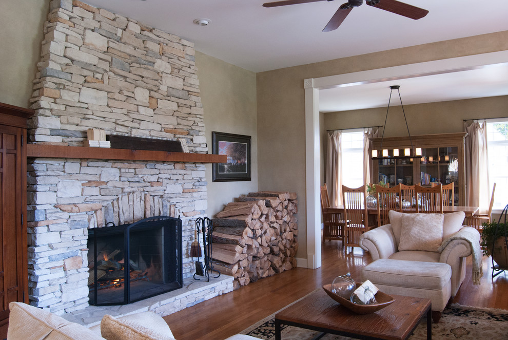 Country living room in Cincinnati with a stone fireplace surround.