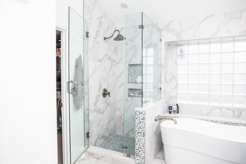 Photo of a large traditional master bathroom in Austin with raised-panel cabinets, blue cabinets, a freestanding tub, a corner shower, multi-coloured tile, marble, white walls, marble floors, an undermount sink, multi-coloured floor, a hinged shower door, white benchtops, a niche, a double vanity and a built-in vanity.
