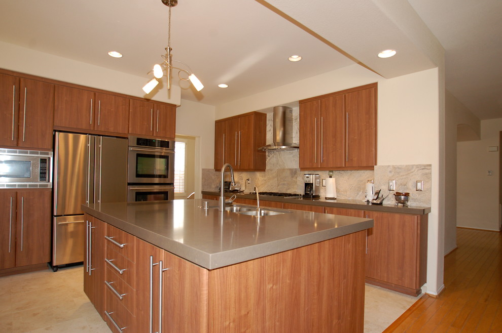 This is an example of a mid-sized midcentury l-shaped open plan kitchen in San Diego with a double-bowl sink, flat-panel cabinets, dark wood cabinets, beige splashback, stone slab splashback, stainless steel appliances, ceramic floors and with island.