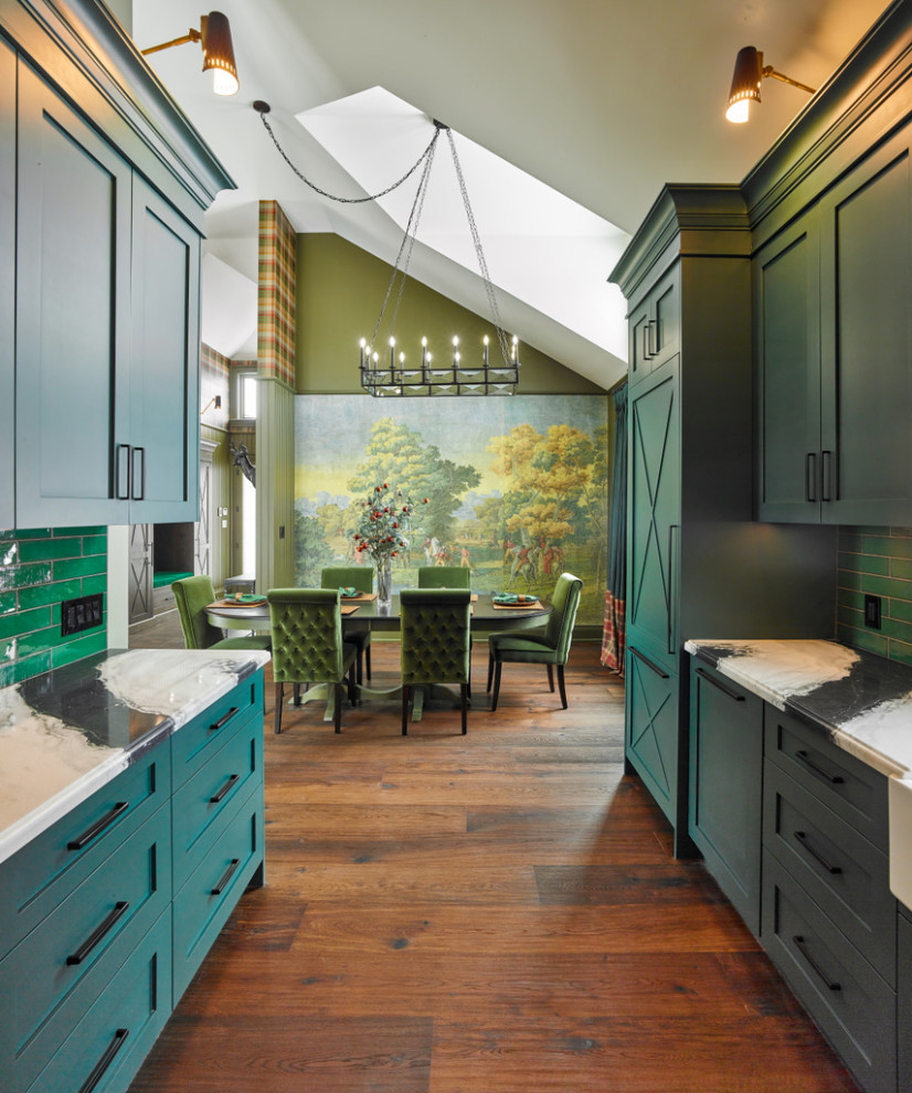 Photo of a small country u-shaped kitchen/diner in Toronto with a belfast sink, shaker cabinets, green cabinets, quartz worktops, green splashback, porcelain splashback, stainless steel appliances, medium hardwood flooring, no island, brown floors, white worktops and a vaulted ceiling.