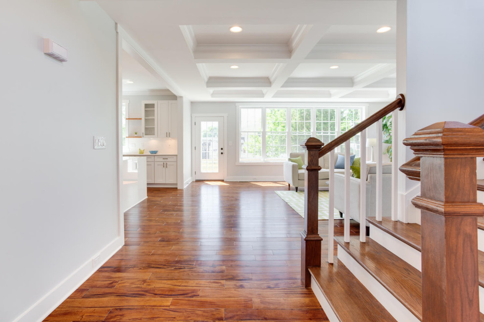 Inspiration for a traditional hallway in DC Metro with grey walls, medium hardwood flooring and a coffered ceiling.