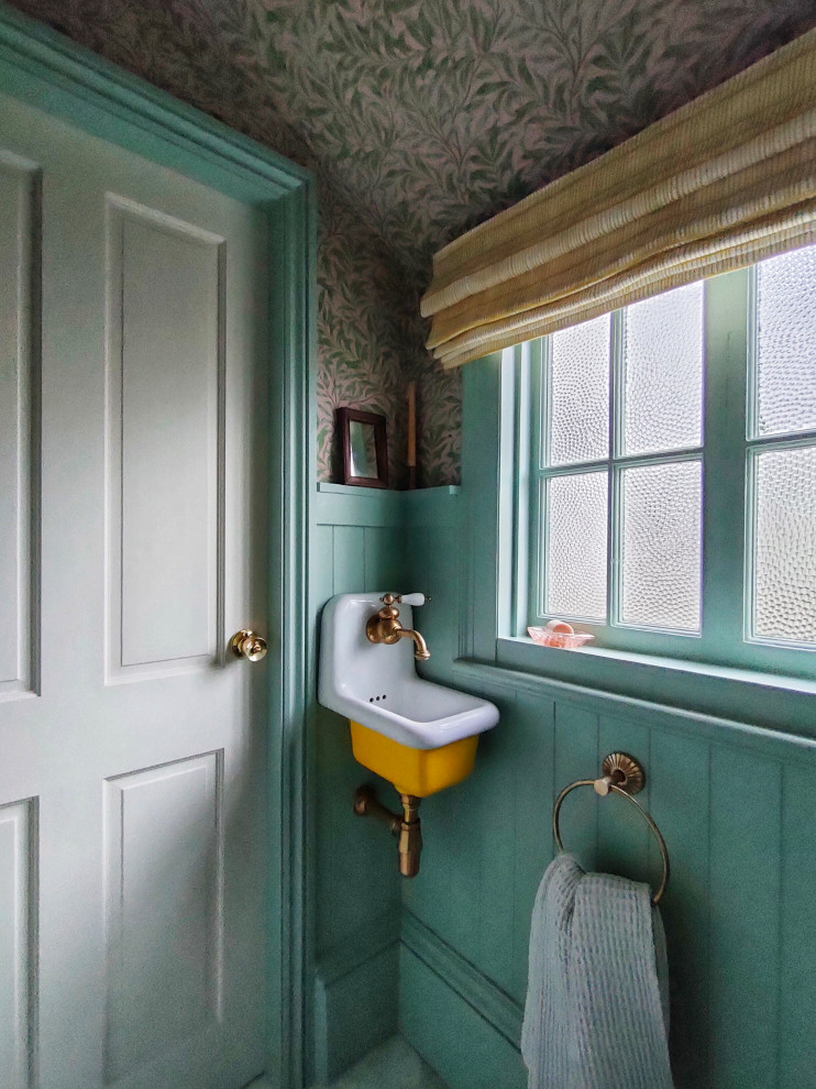 This is an example of a large arts and crafts powder room in Other with furniture-like cabinets, yellow cabinets, a one-piece toilet, marble floors, a wall-mount sink and a floating vanity.