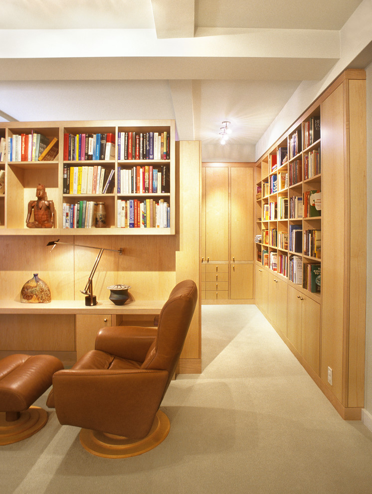 Photo of a mid-sized contemporary home office in New York with white walls.