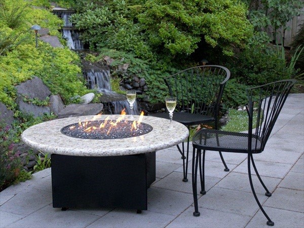 Gas Fire Pit with natural waterfall by Oriflamme Fire Tables.   This amazing photo features the unique propane or natural gas fire pit from All Backyard Fun.