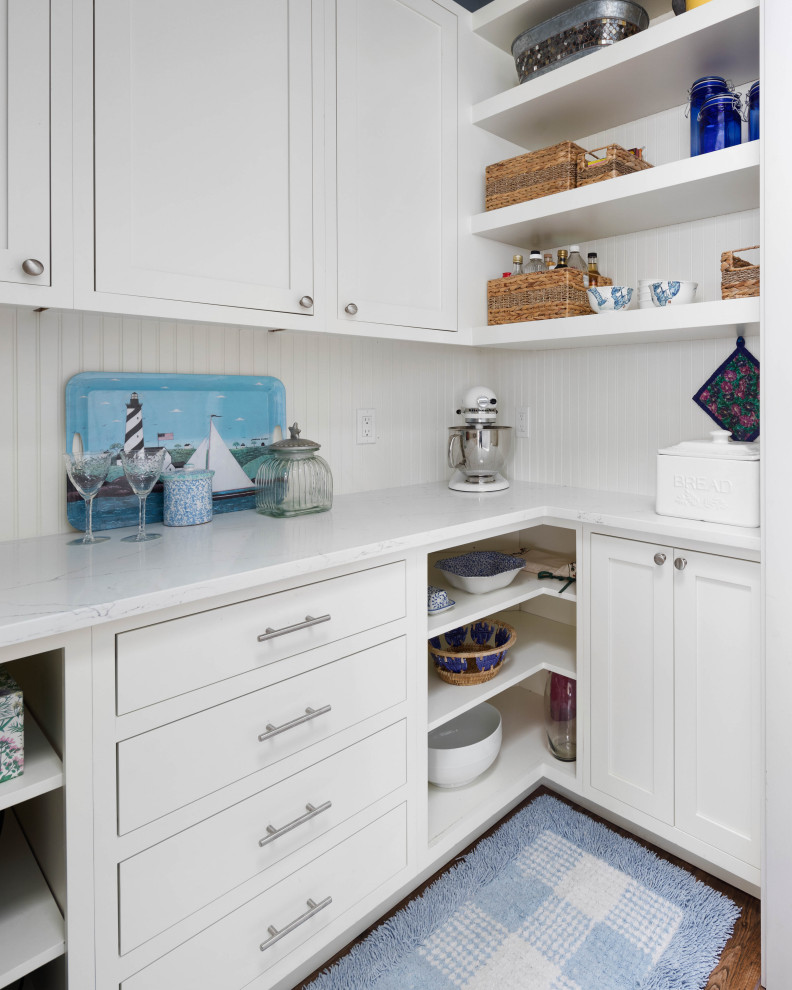 Inspiration for a large traditional kitchen pantry in Seattle with an undermount sink, shaker cabinets, blue cabinets, quartz benchtops, blue splashback, ceramic splashback, stainless steel appliances, porcelain floors, with island, brown floor and white benchtop.