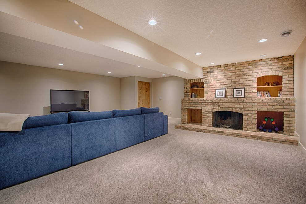 Basement - large transitional look-out carpeted basement idea in Calgary with beige walls, a standard fireplace and a brick fireplace