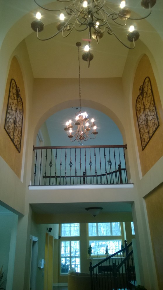 Example of a large transitional medium tone wood floor foyer design in Chicago with beige walls