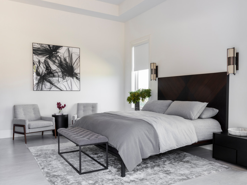 Photo of a contemporary master bedroom in Houston with white walls and grey floor.