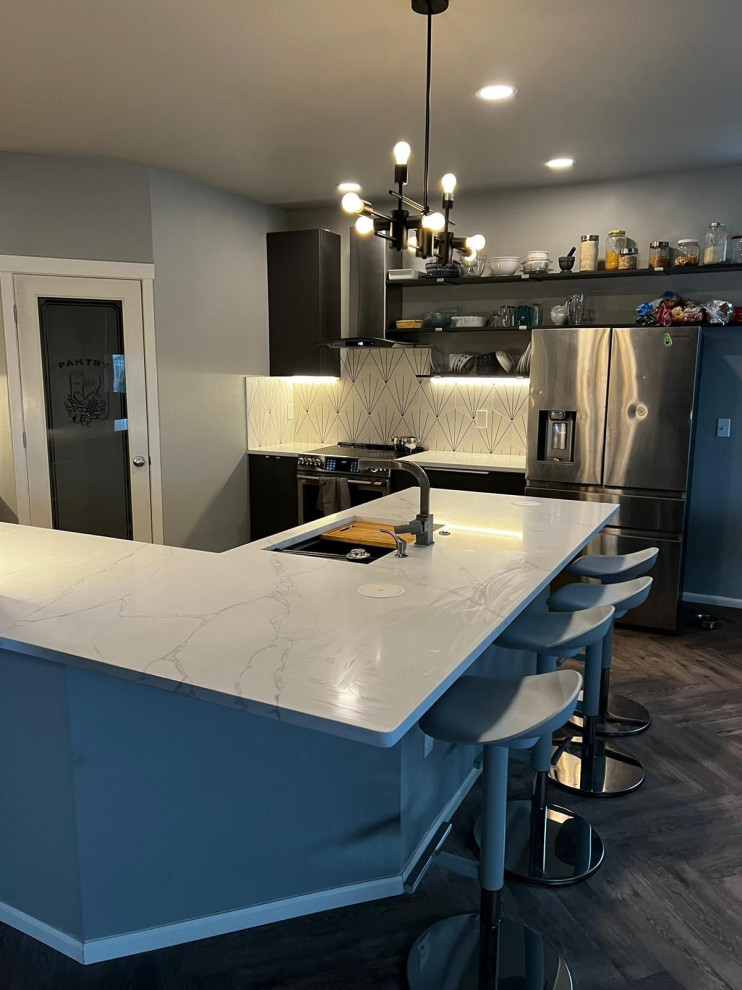 Medium sized contemporary l-shaped kitchen/diner in Seattle with a submerged sink, flat-panel cabinets, dark wood cabinets, quartz worktops, an island, beige floors and white worktops.
