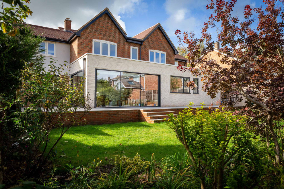 Design ideas for a large contemporary two floor brick detached house in Oxfordshire with a pitched roof, a tiled roof and a brown roof.