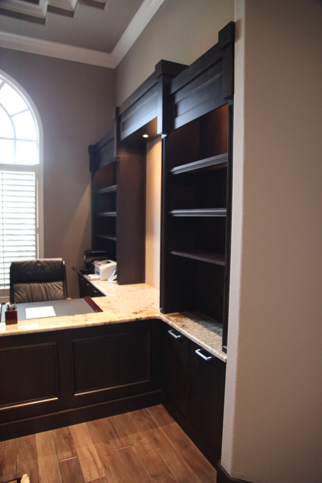 Inspiration for a large contemporary study room in Orlando with a built-in desk and medium hardwood floors.