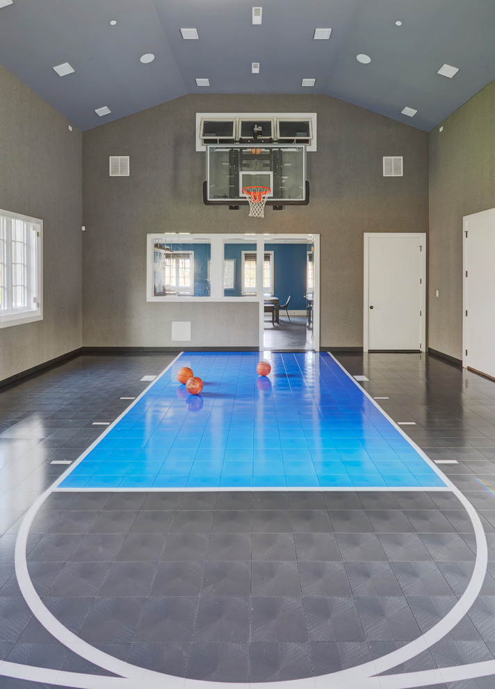 Photo of an expansive modern indoor sport court in Chicago with grey walls and blue floor.