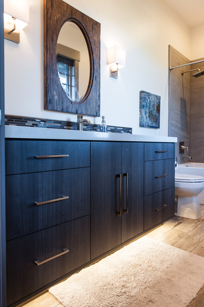 This is an example of a mid-sized 3/4 bathroom in Salt Lake City with recessed-panel cabinets and dark wood cabinets.