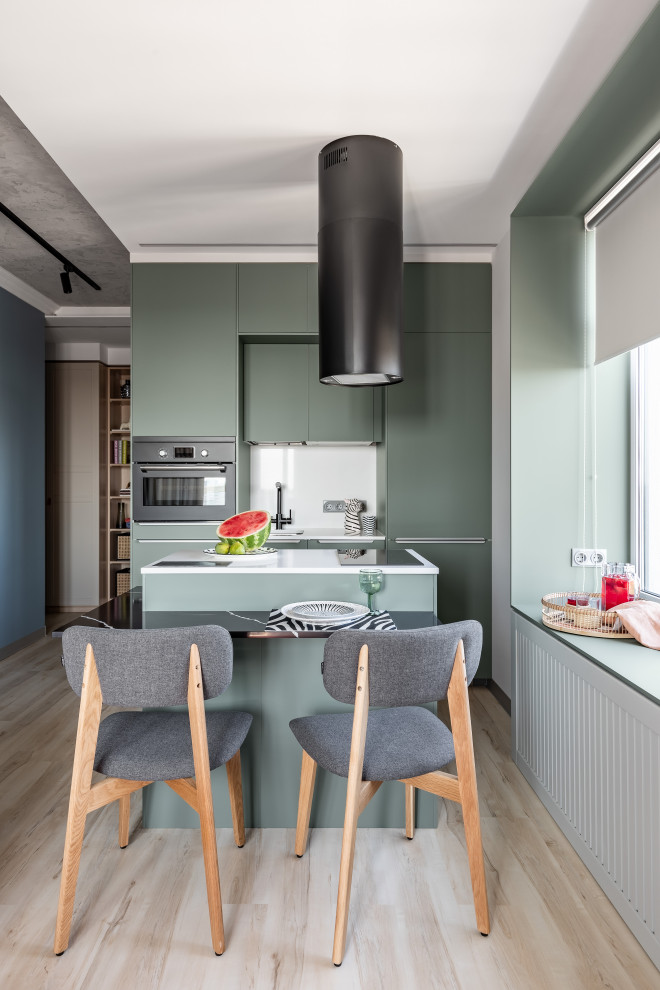 Small contemporary single-wall eat-in kitchen in Saint Petersburg with green cabinets, marble benchtops, stainless steel appliances, medium hardwood floors, beige floor and white benchtop.
