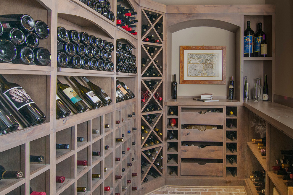 Photo of a traditional wine cellar in Other with brick floors and diamond bins.