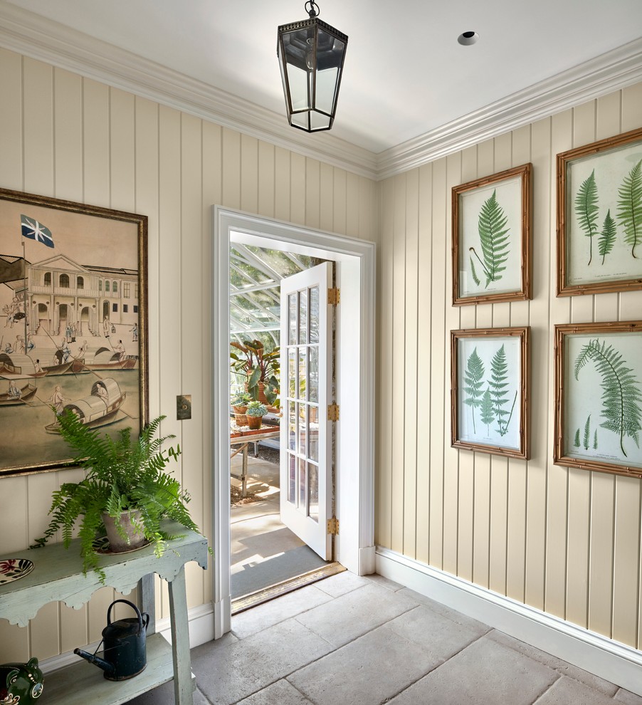 Inspiration for a large traditional mudroom in New York with beige walls, a single front door, a glass front door, concrete floors and grey floor.